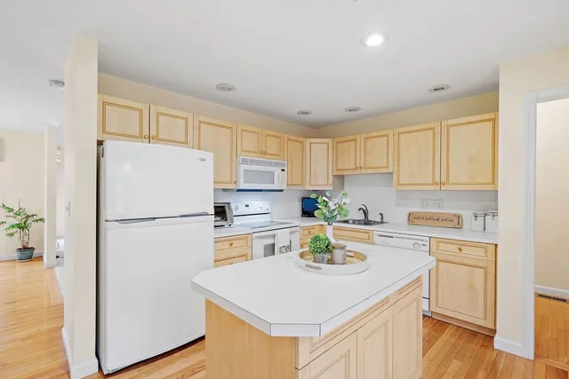 a white refrigerator freezer sitting inside of a kitchen