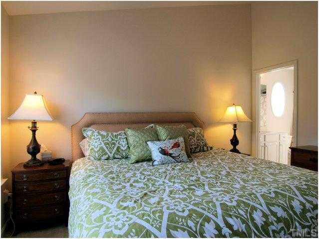 8220 City Loft Court Raleigh, NC 27613 - Photo 14 of 19 a bedroom with a bed and a lamp on table