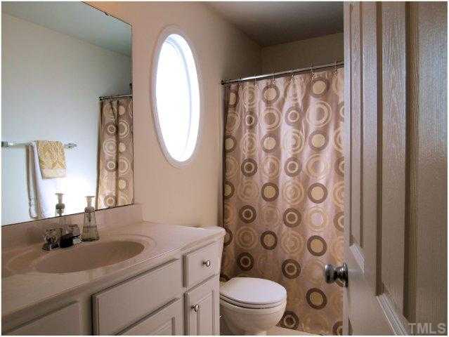 8220 City Loft Court Raleigh, NC 27613 - Photo 15 of 19 a bathroom with a toilet sink and mirror