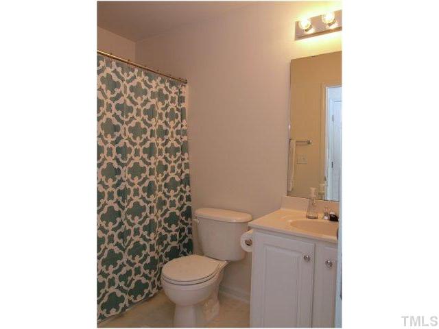 8220 City Loft Court Raleigh, NC 27613 - Photo 17 of 19 a bathroom with a toilet and a shower