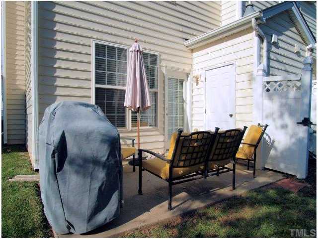 8220 City Loft Court Raleigh, NC 27613 - Photo 3 of 19 a building outdoor space with patio furniture and potted plants