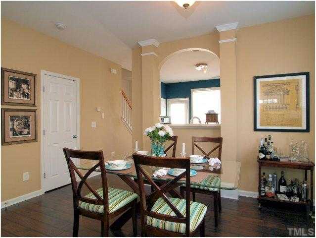 8220 City Loft Court Raleigh, NC 27613 - Photo 6 of 19 a view of a dining room with furniture and wooden floor