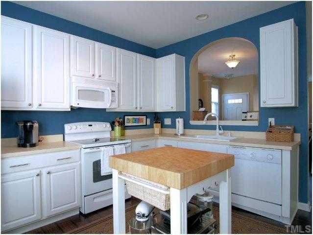 8220 City Loft Court Raleigh, NC 27613 - Photo 10 of 19 a kitchen with a sink a stove and cabinets