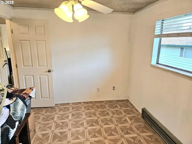 a view of a livingroom with wooden floor and a window