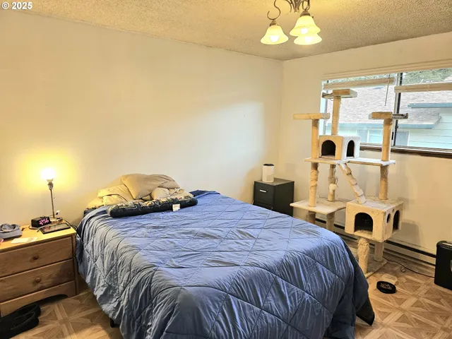 a bedroom with a bed and a chandelier