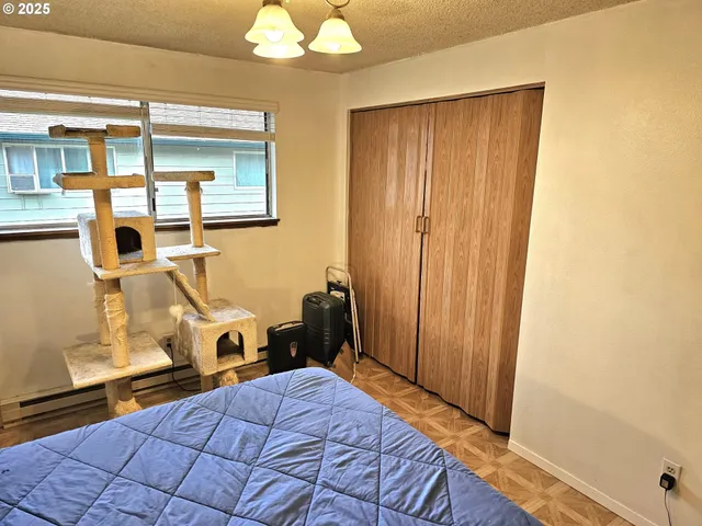 a bedroom with a bed and a chandelier