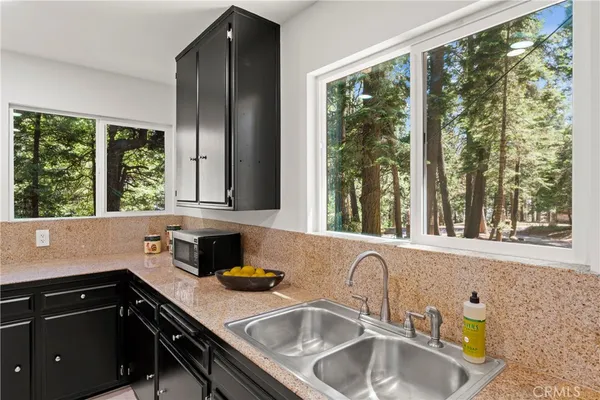a kitchen with granite countertop a sink and a window