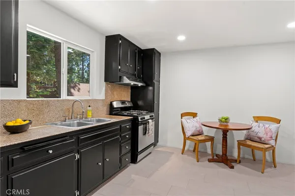 a kitchen with a sink a stove and a microwave