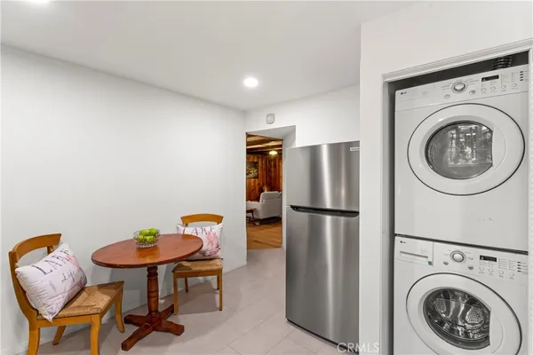 a kitchen with stainless steel appliances refrigerator and dining table