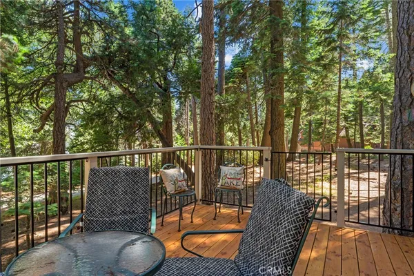 a view of balcony with floor to ceiling window and wooden fence