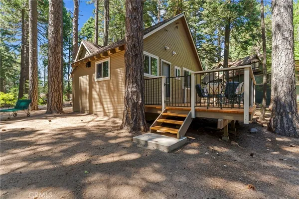 a view of outdoor space with deck and tree