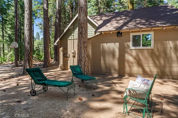 a backyard of a house with table and chairs