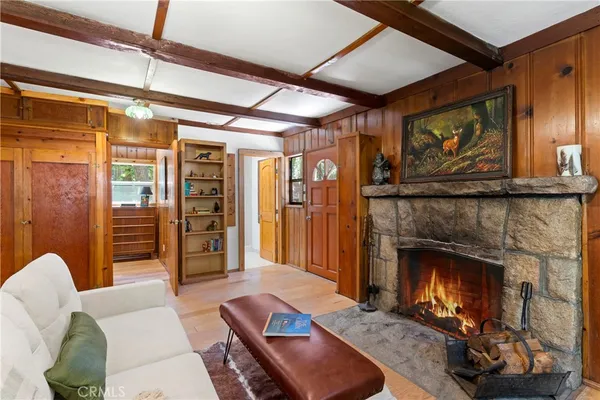 a living room with furniture a fireplace and a table
