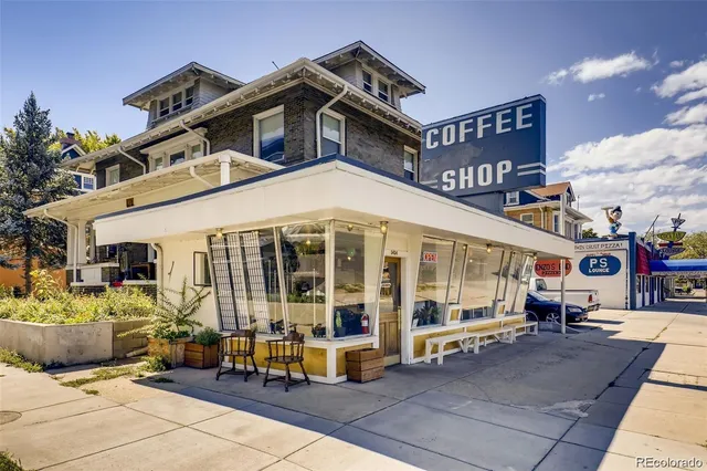 a front view of a building with sitting area