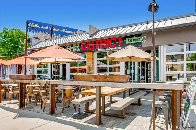 a view of a cafe with a table and chairs under an umbrella
