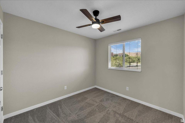 3155 South Hidden Dr Street, Unit 248 St. George, UT 84790 - Photo 13 of 24 Room featuring a ceiling fan with integrated lighting, a window with horizontal blinds, neutral wall paint, white baseboards, and carpet flooring