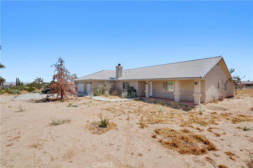 13227 Smith Road Phelan, CA 92371 - Photo 1 of 1 a front view of a house with a yard
