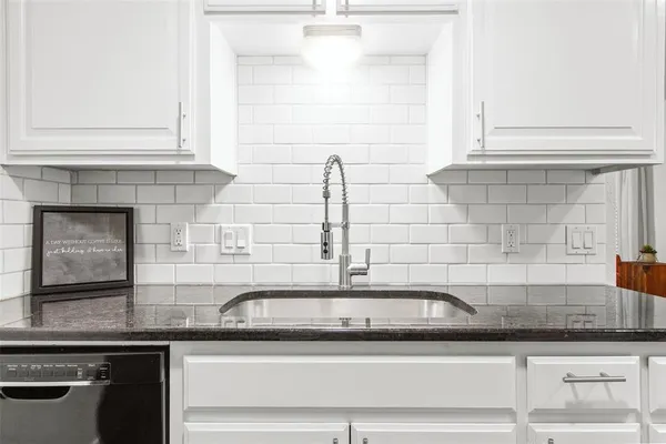 a kitchen with granite countertop a sink and a granite counter tops