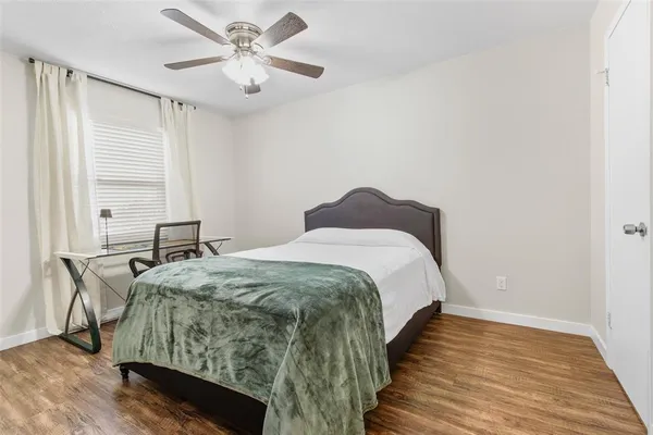 a spacious bedroom with a bed and a table