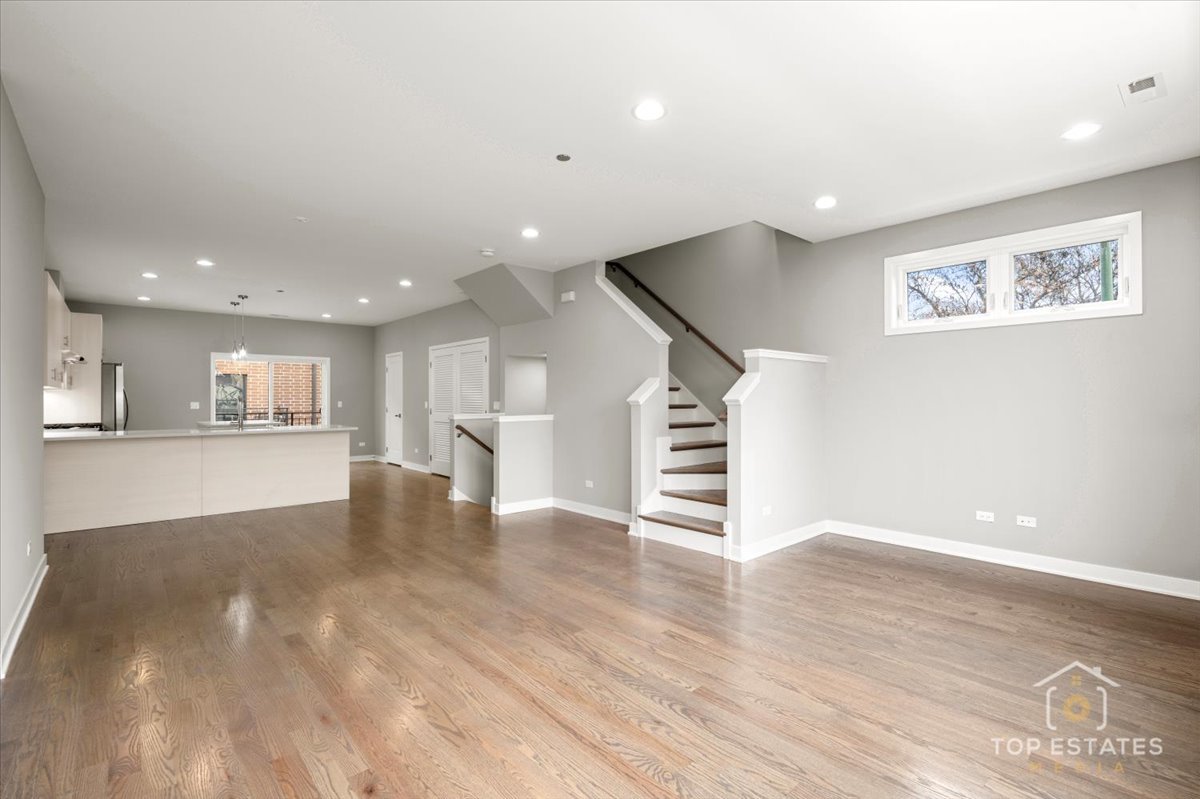 3638 South Western Avenue, Unit F Chicago, IL 60632 - Photo 14 of 36 a view of an empty room with wooden floor and a kitchen