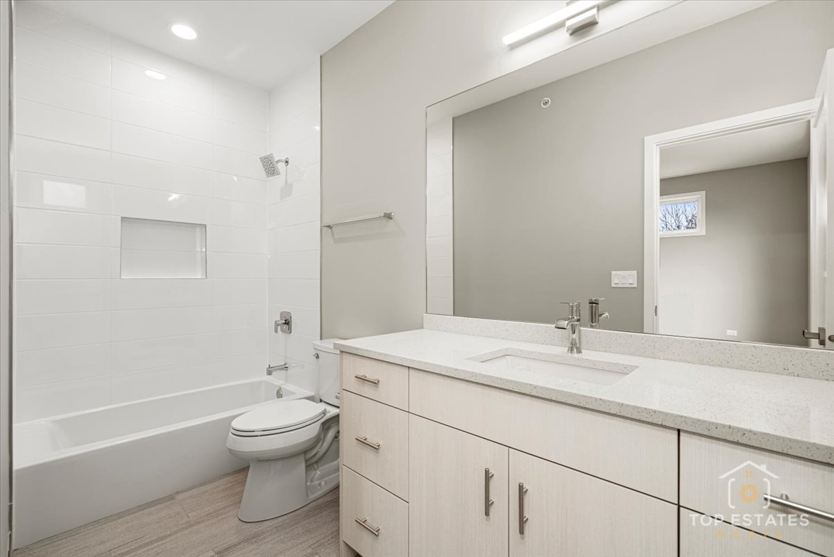 3638 South Western Avenue, Unit F Chicago, IL 60632 - Photo 24 of 36 a bathroom with a sink toilet vanity and tub