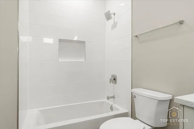 a bathroom with a toilet and a bathtub