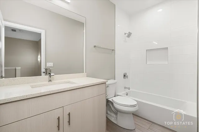 a bathroom with a sink a toilet and a large mirror