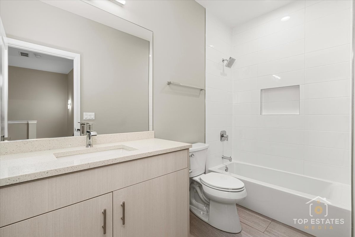 3638 South Western Avenue, Unit F Chicago, IL 60632 - Photo 28 of 36 a bathroom with a sink a toilet and a large mirror