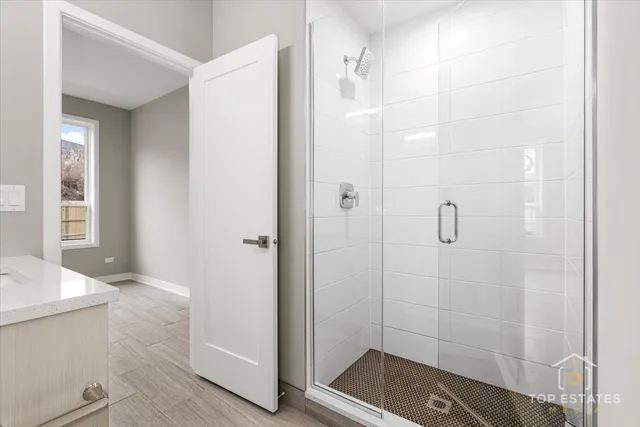a bathroom with a shower and a sink