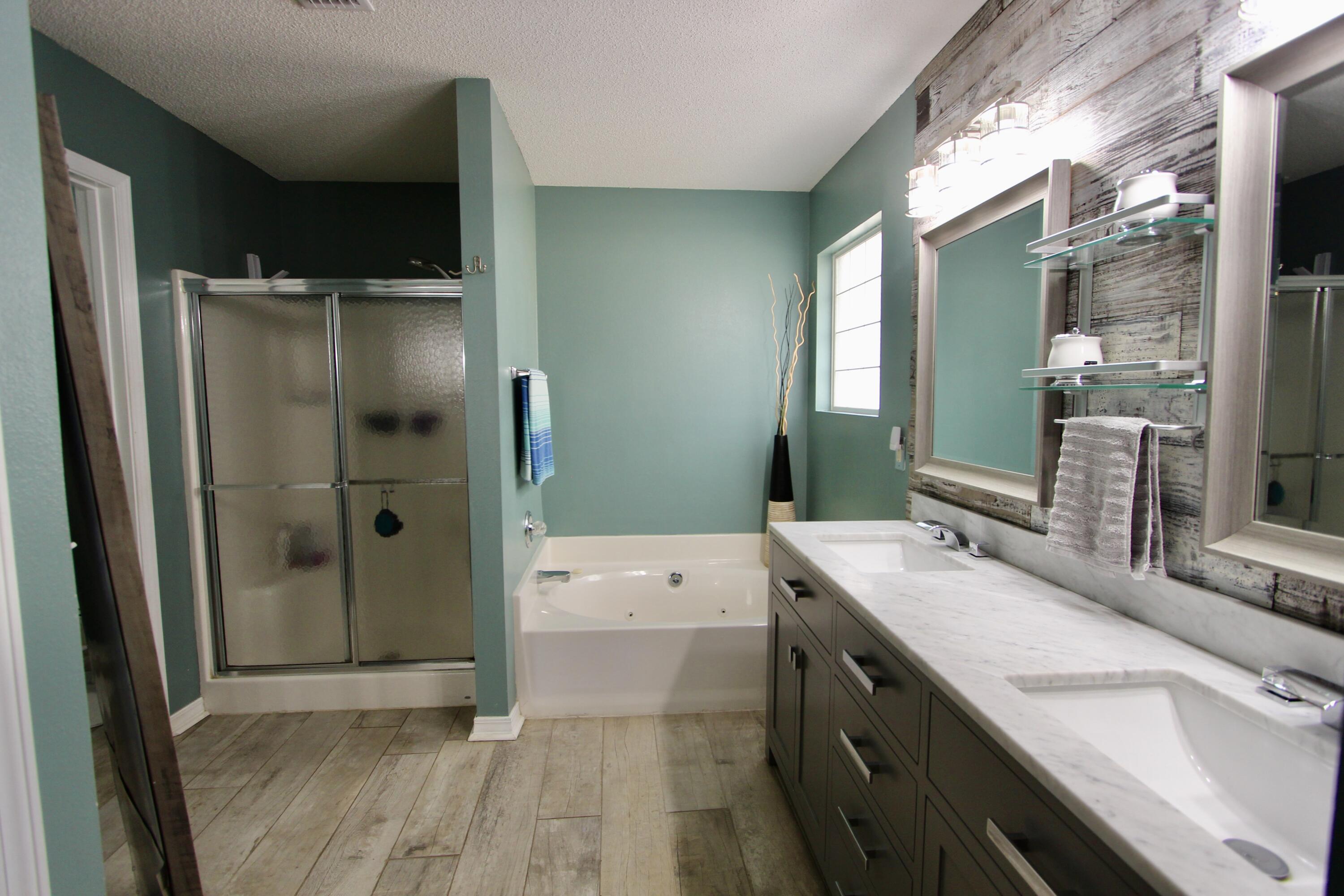 7183 Riverview Road Navarre, FL 32566 - Photo 20 of 39 a spacious bathroom with a double vanity sink mirror and shower