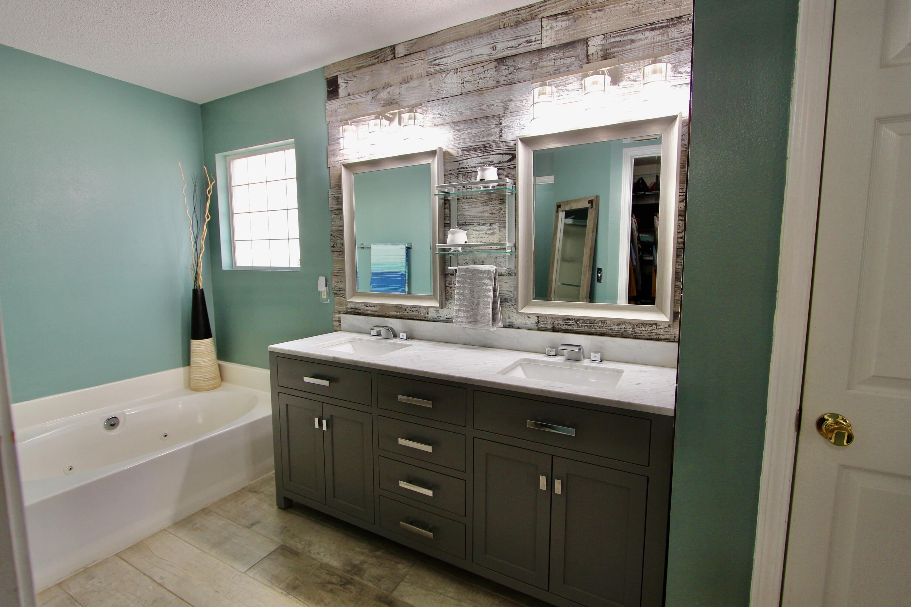 7183 Riverview Road Navarre, FL 32566 - Photo 21 of 39 a bathroom with a double vanity sink mirror and bathtub