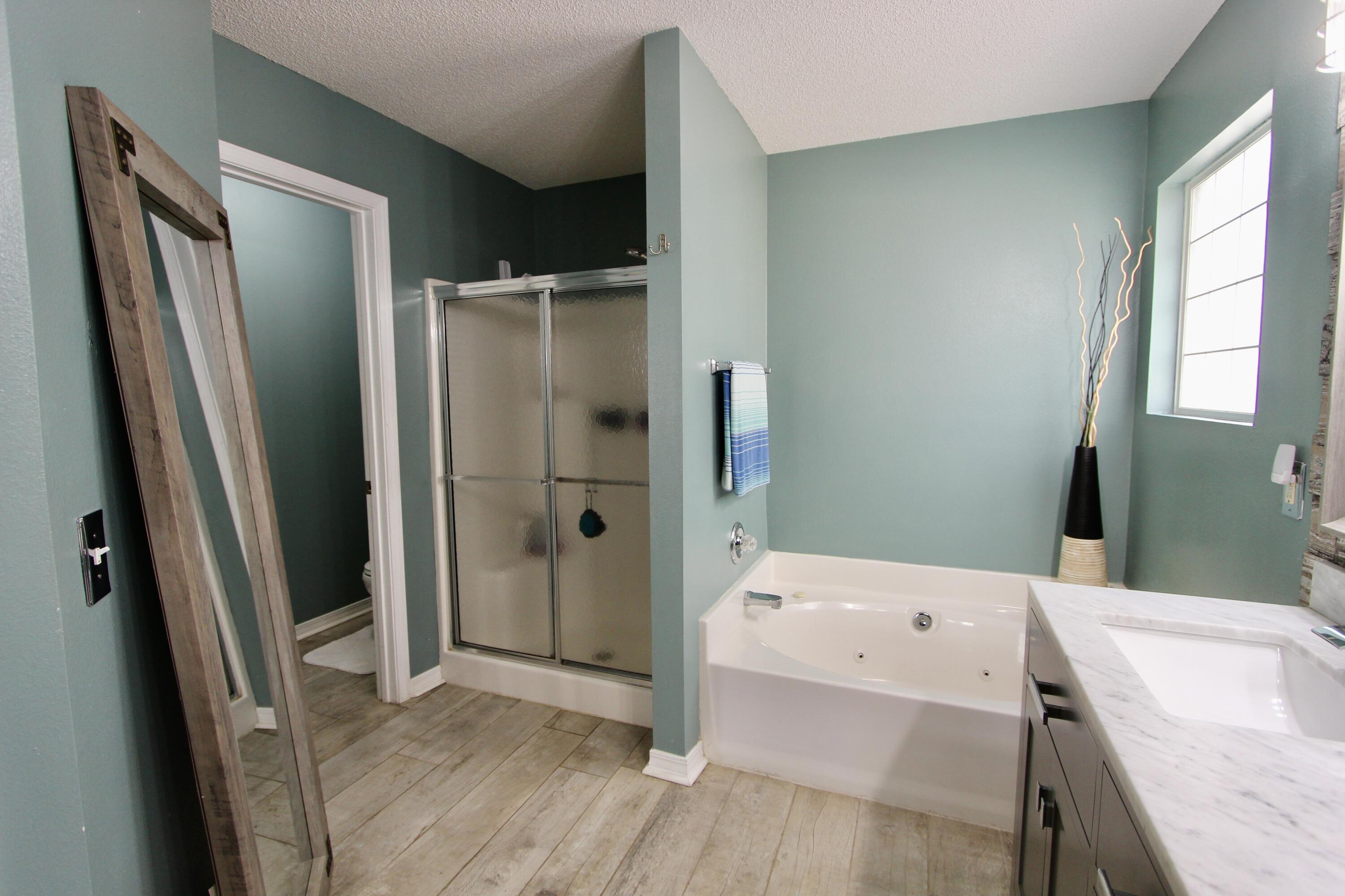 7183 Riverview Road Navarre, FL 32566 - Photo 22 of 39 a bathroom with a tub sink and a mirror