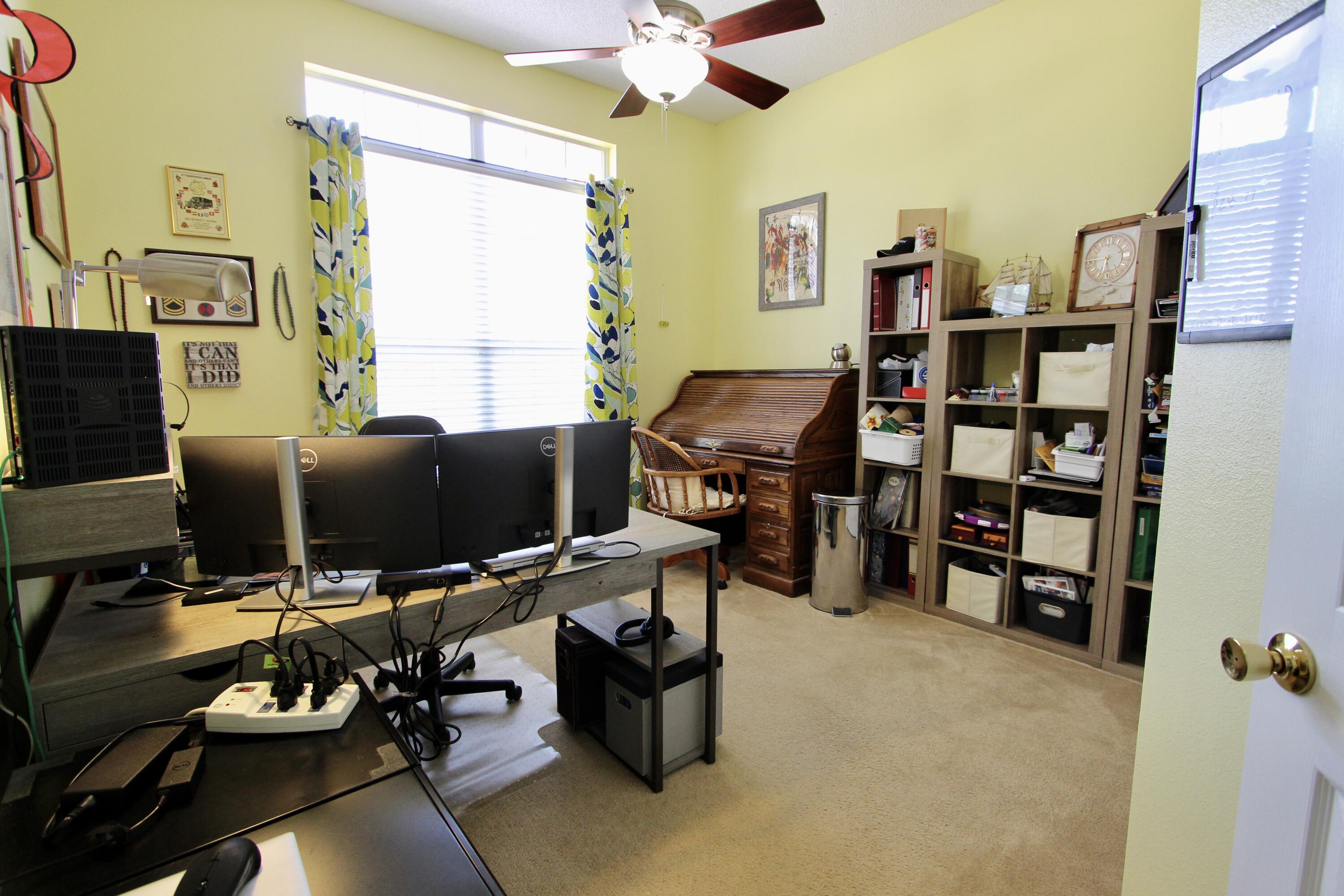 7183 Riverview Road Navarre, FL 32566 - Photo 25 of 39 a view of a workspace with furniture and a window