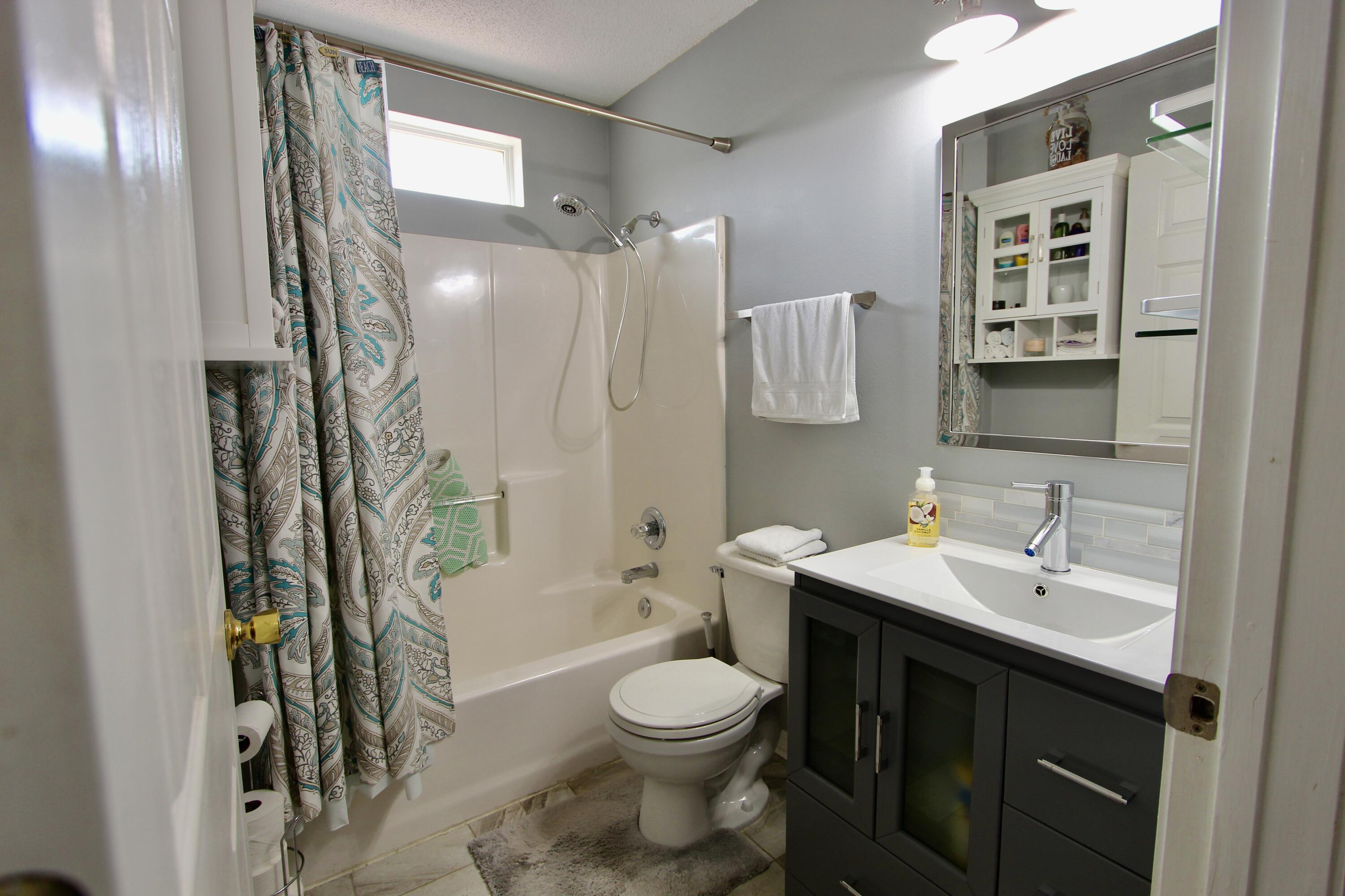 7183 Riverview Road Navarre, FL 32566 - Photo 27 of 39 a bathroom with a sink toilet and shower