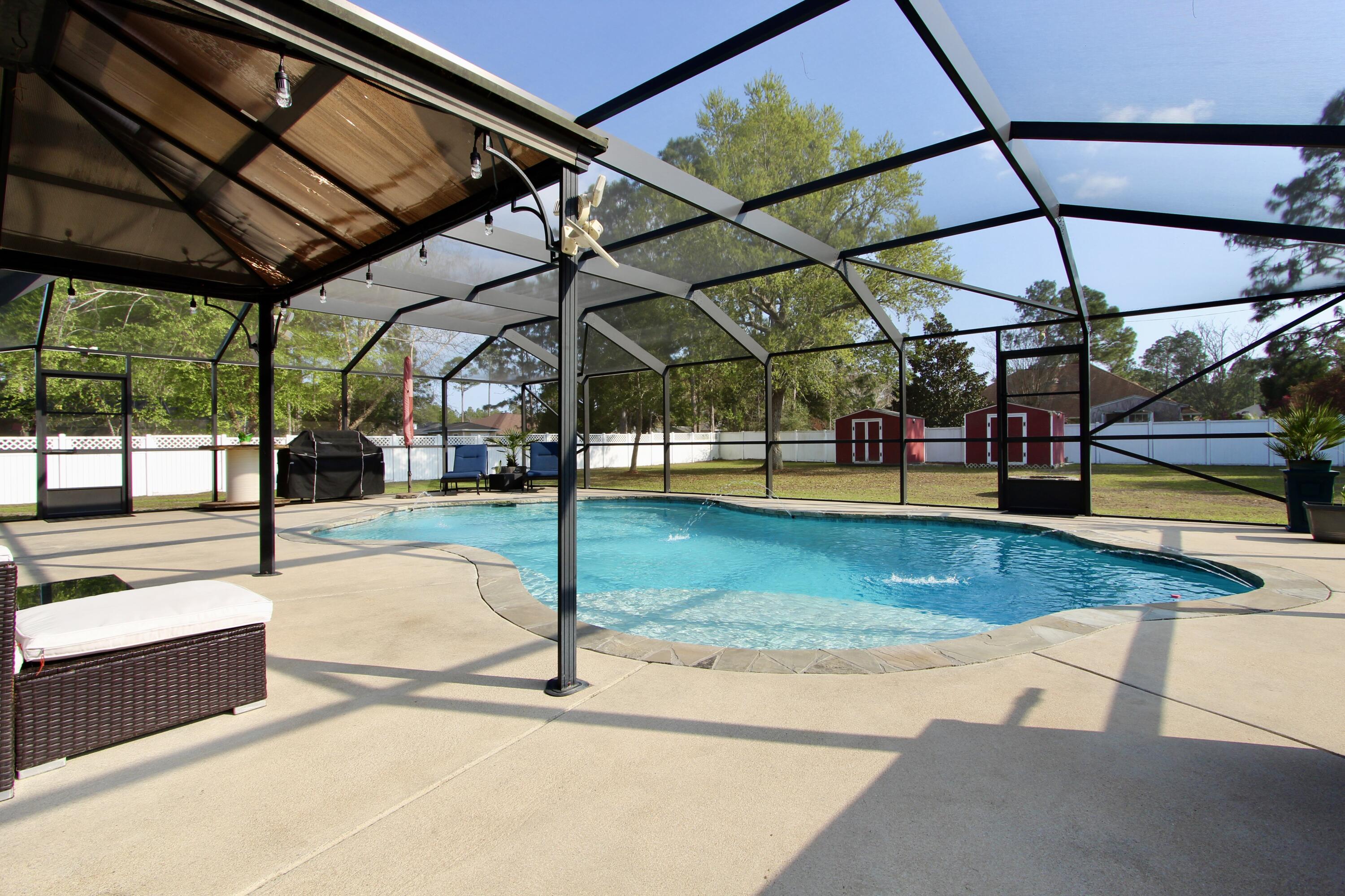 7183 Riverview Road Navarre, FL 32566 - Photo 30 of 39 a view of a swimming pool with a porch