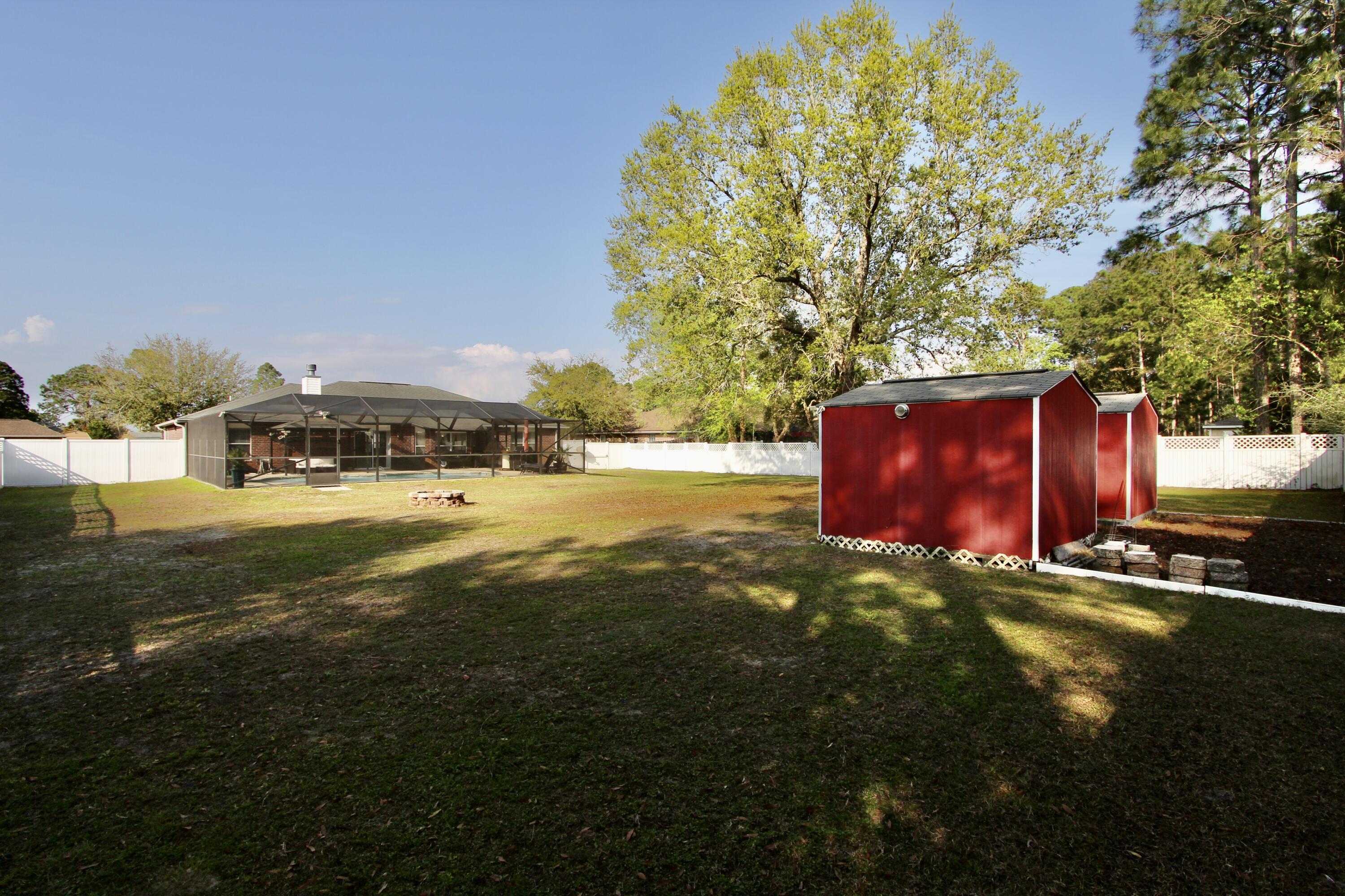 7183 Riverview Road Navarre, FL 32566 - Photo 34 of 39 a view of a yard with an trees