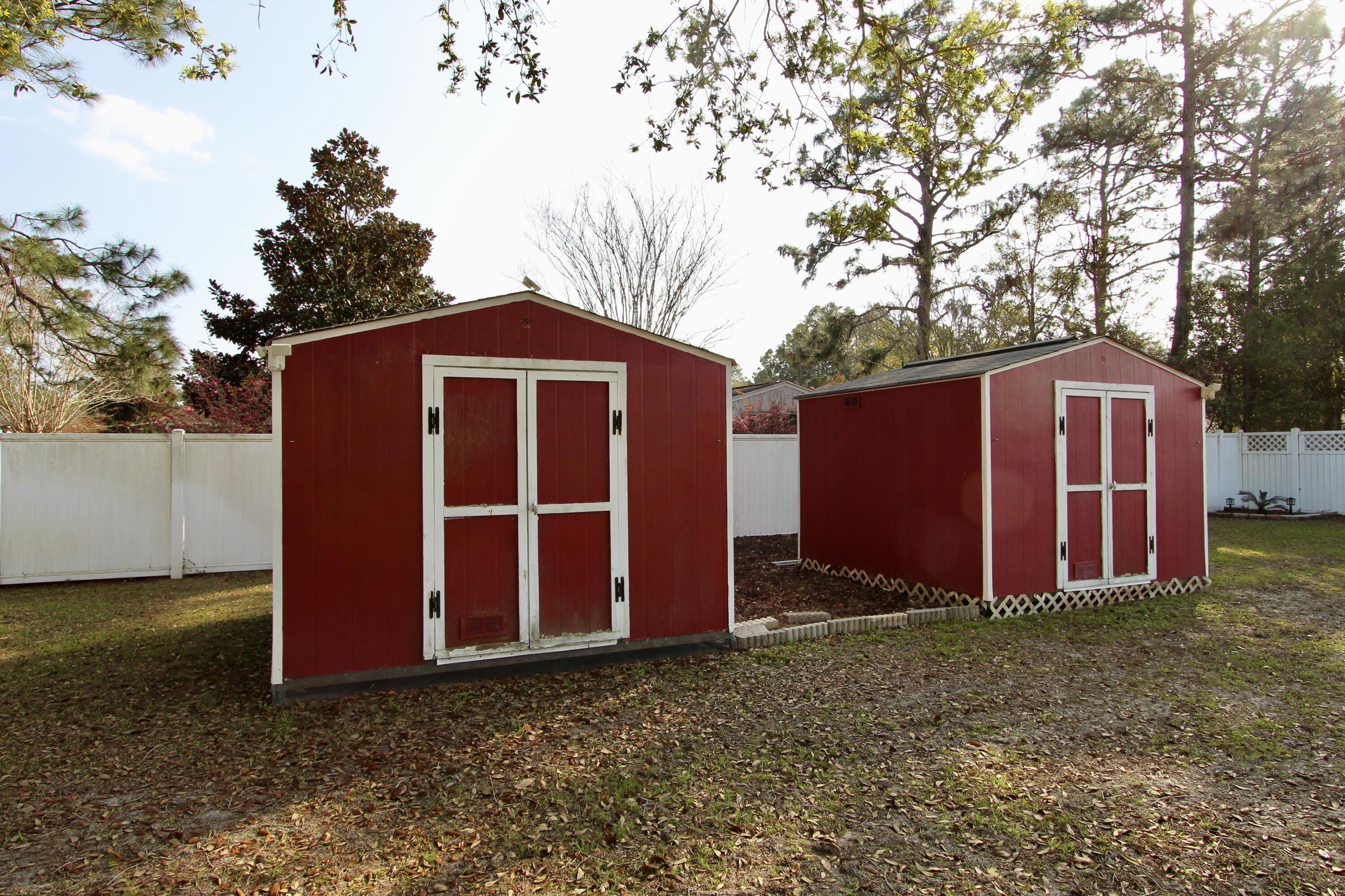 7183 Riverview Road Navarre, FL 32566 - Photo 36 of 39 a view of barn with wooden fence and large trees