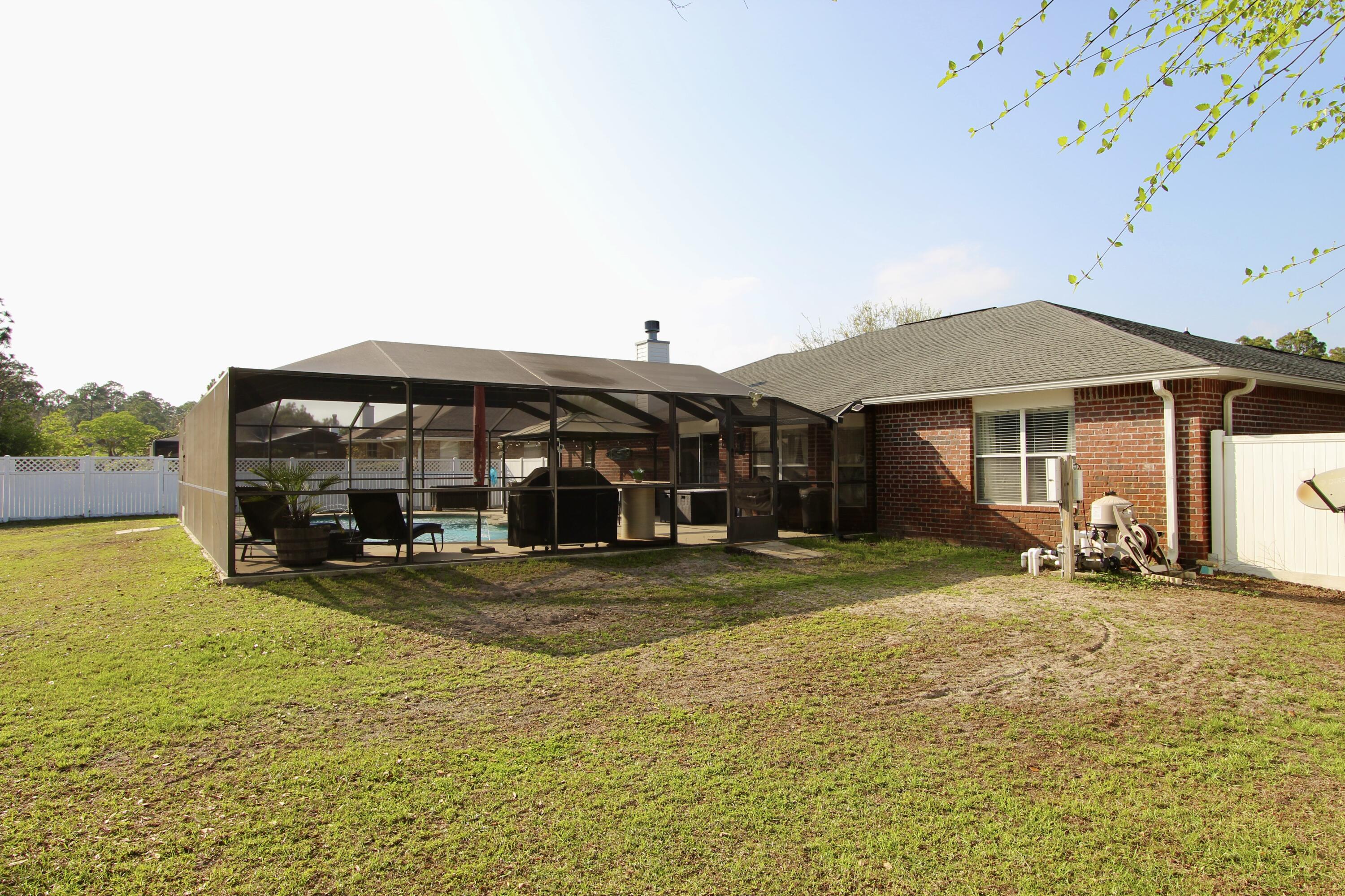 7183 Riverview Road Navarre, FL 32566 - Photo 38 of 39 a view of a house with swimming pool