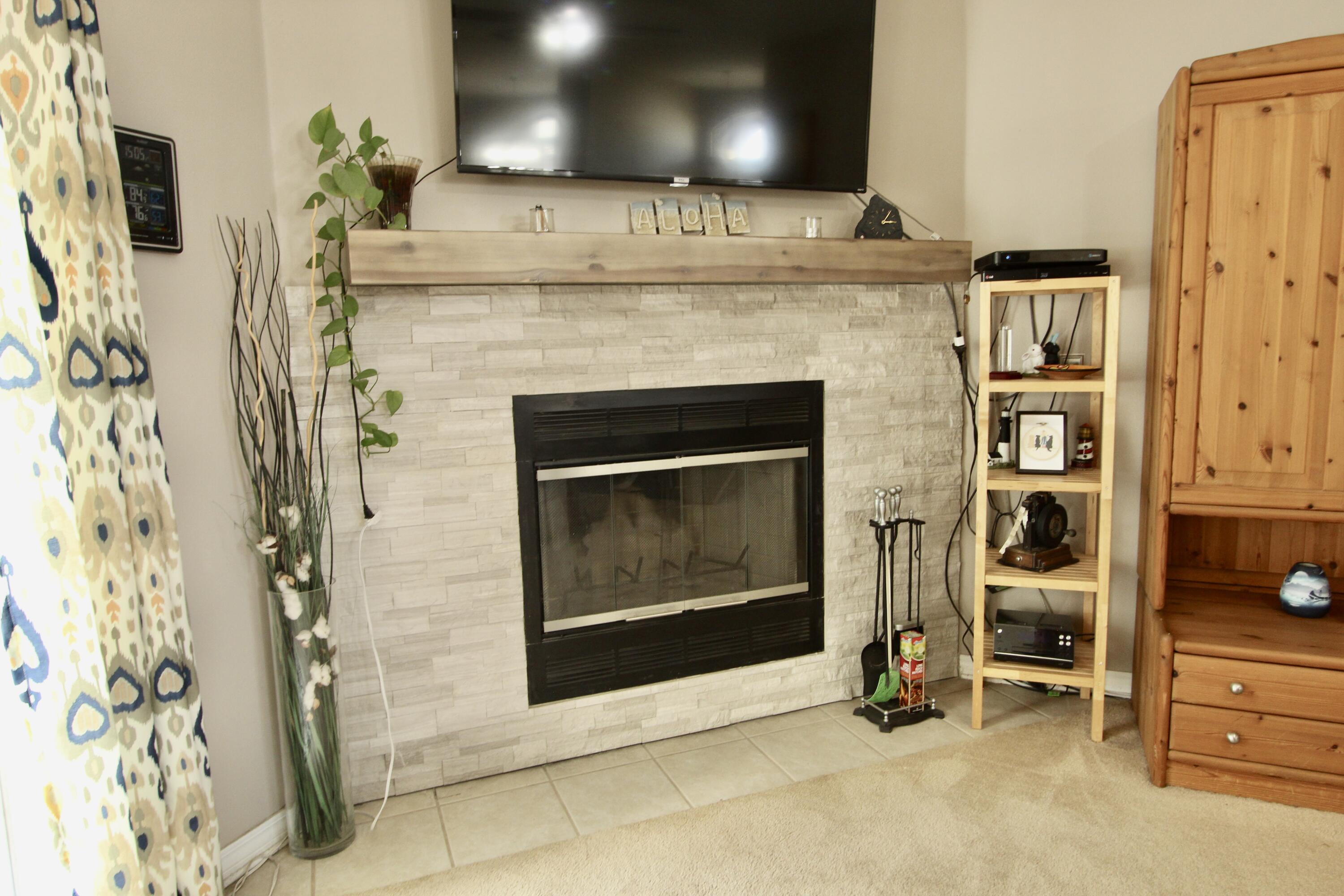 7183 Riverview Road Navarre, FL 32566 - Photo 7 of 39 a living room with a fireplace and a fireplace