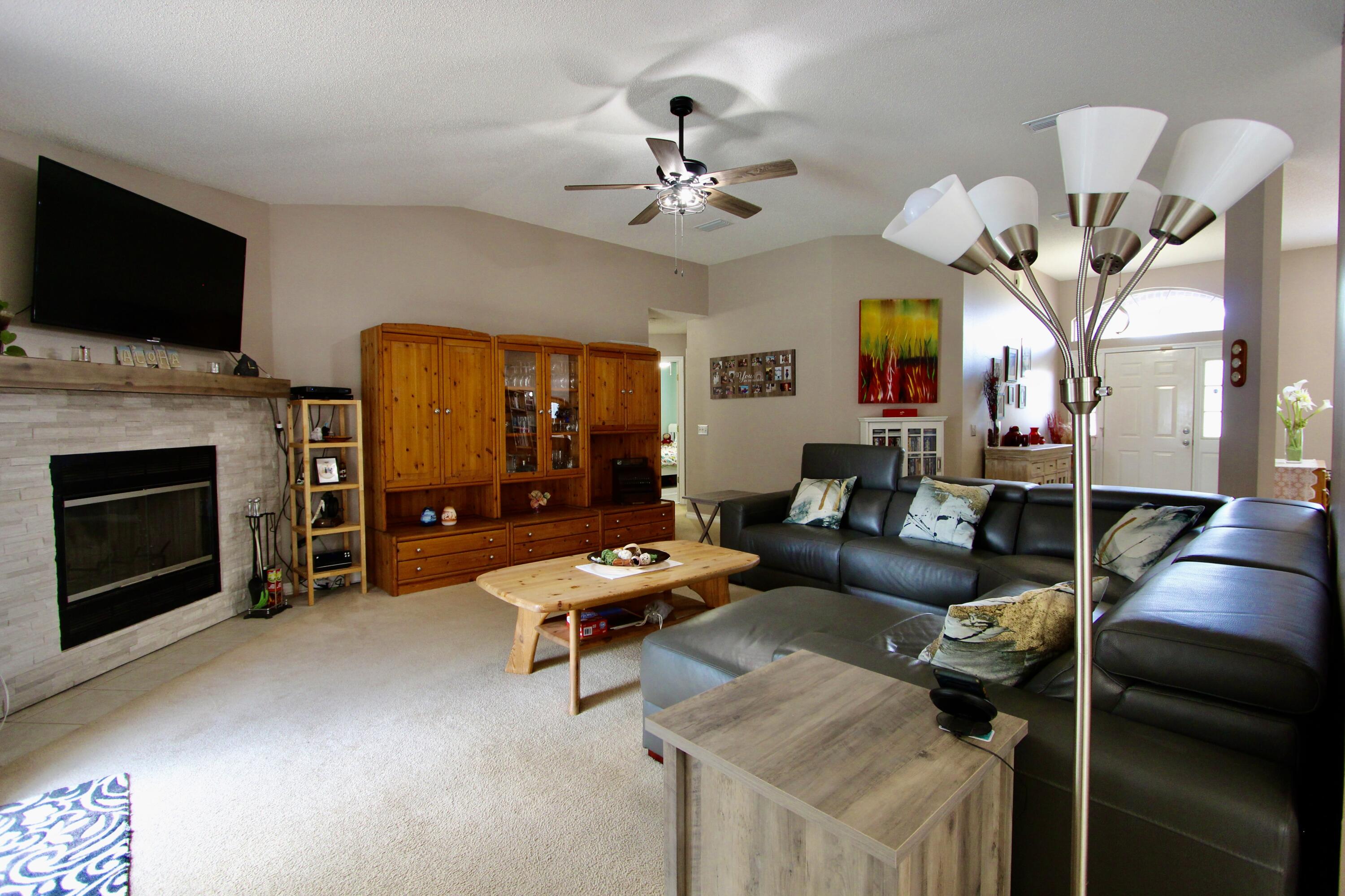 7183 Riverview Road Navarre, FL 32566 - Photo 9 of 39 a living room with furniture fireplace and flat screen tv