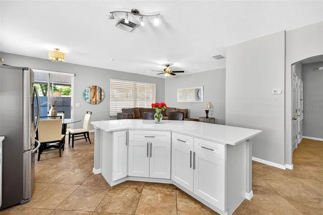 a living room with furniture and kitchen view