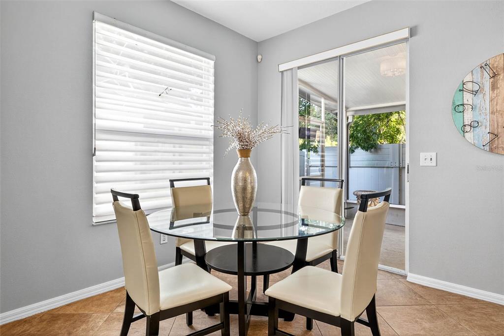 8853 Cypress Hammock Drive Tampa, FL 33614 - Photo 16 of 41 a view of a dining room with furniture window and wooden floor