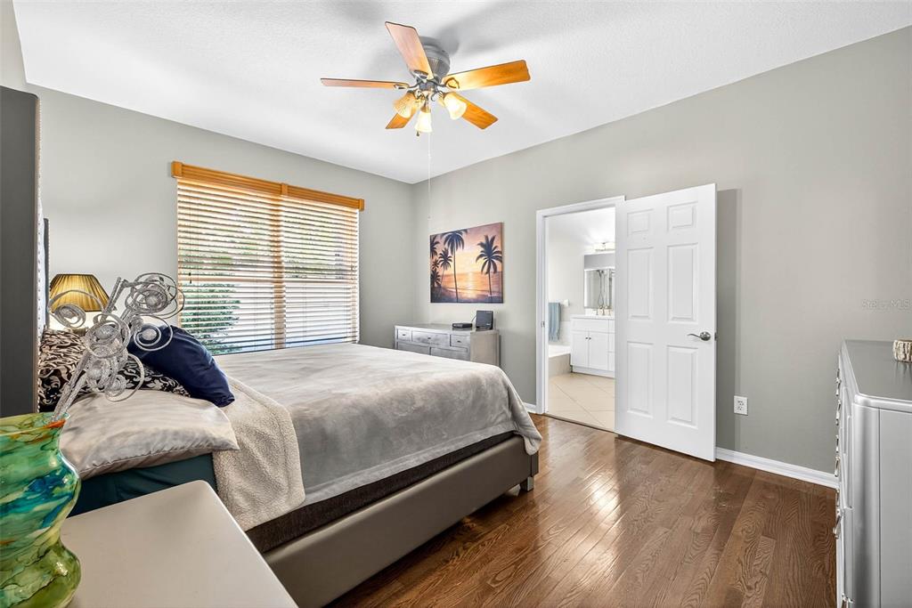 8853 Cypress Hammock Drive Tampa, FL 33614 - Photo 21 of 41 a bedroom with a bed and a chandelier