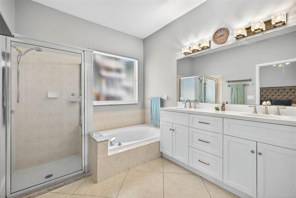 8853 Cypress Hammock Drive Tampa, FL 33614 - Photo 24 of 41 a bathroom with a tub sink shower and mirror