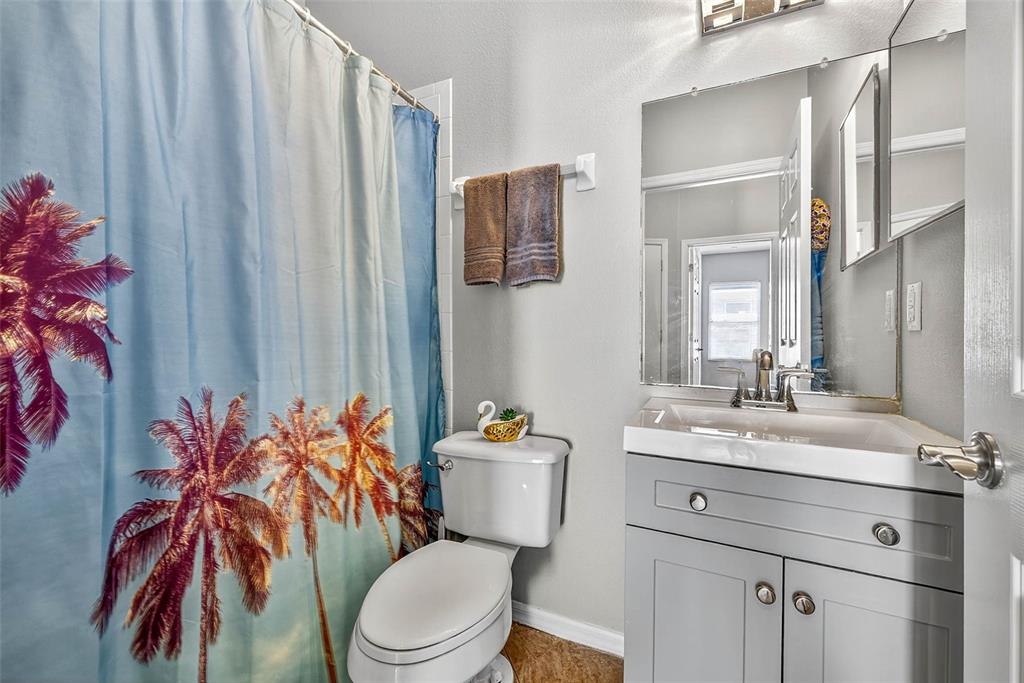 8853 Cypress Hammock Drive Tampa, FL 33614 - Photo 31 of 41 a bathroom with a sink vanity mirror and toilet