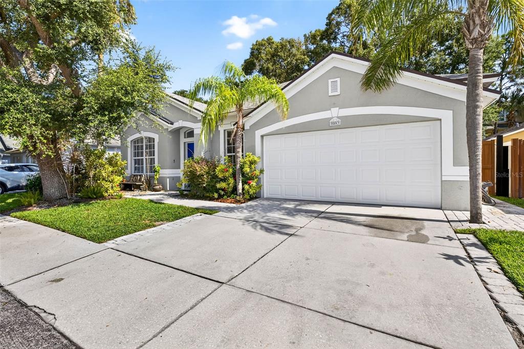 8853 Cypress Hammock Drive Tampa, FL 33614 - Photo 37 of 41 a front view of a house with a yard and a garage