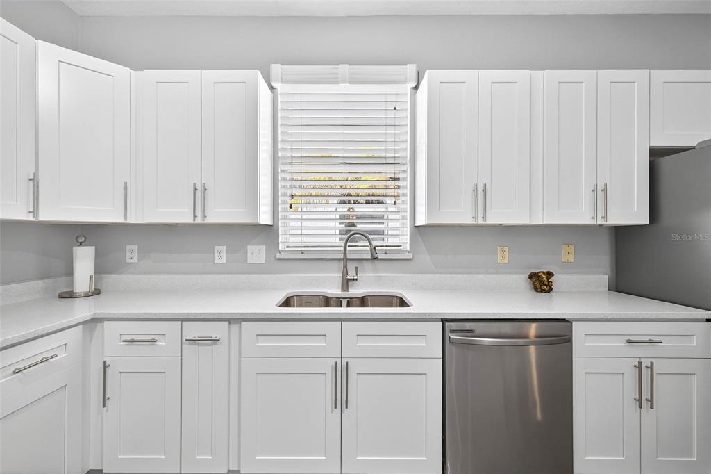 8853 Cypress Hammock Drive Tampa, FL 33614 - Photo 10 of 41 a kitchen with white cabinets and white appliances