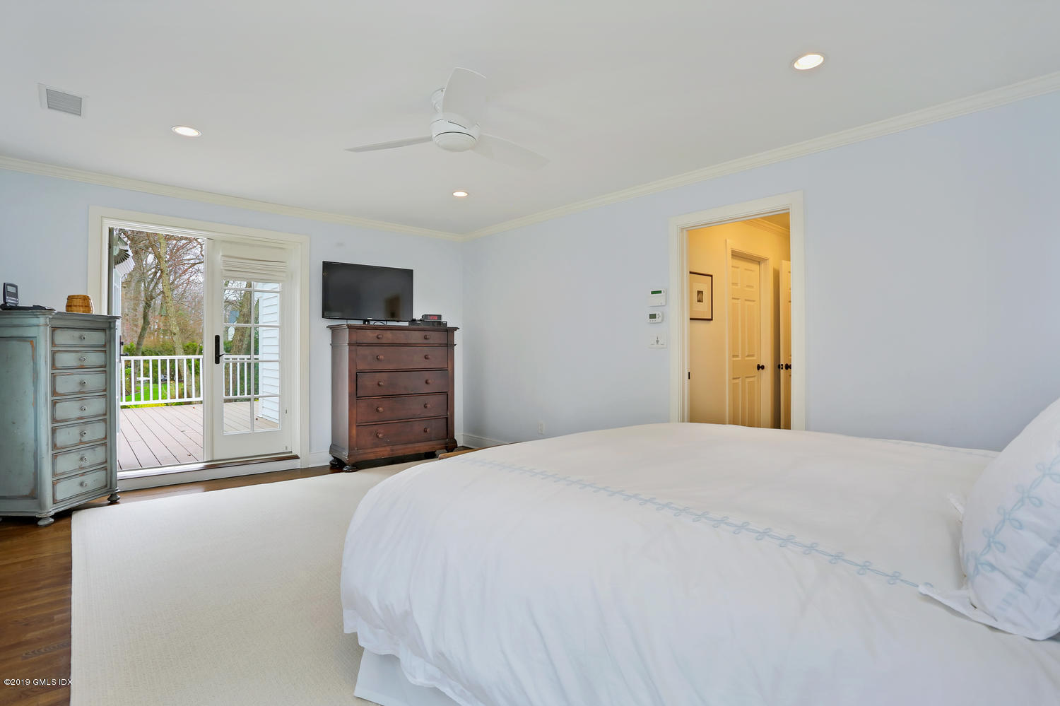 58 Indian Head Road Riverside, CT 06878 - Photo 19 of 33 a spacious bedroom with a bed and a dresser
