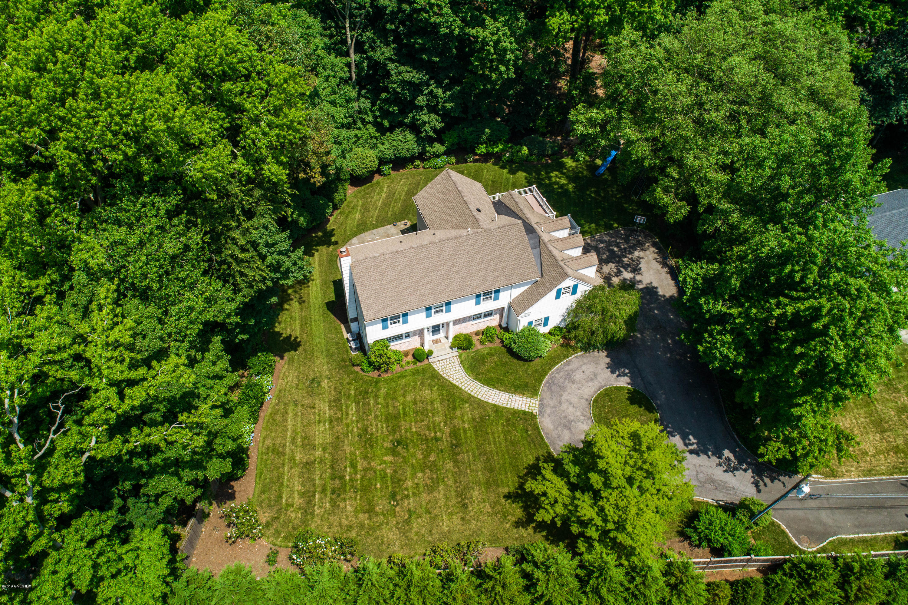 58 Indian Head Road Riverside, CT 06878 - Photo 29 of 33 an aerial view of a house with a swimming pool and garden
