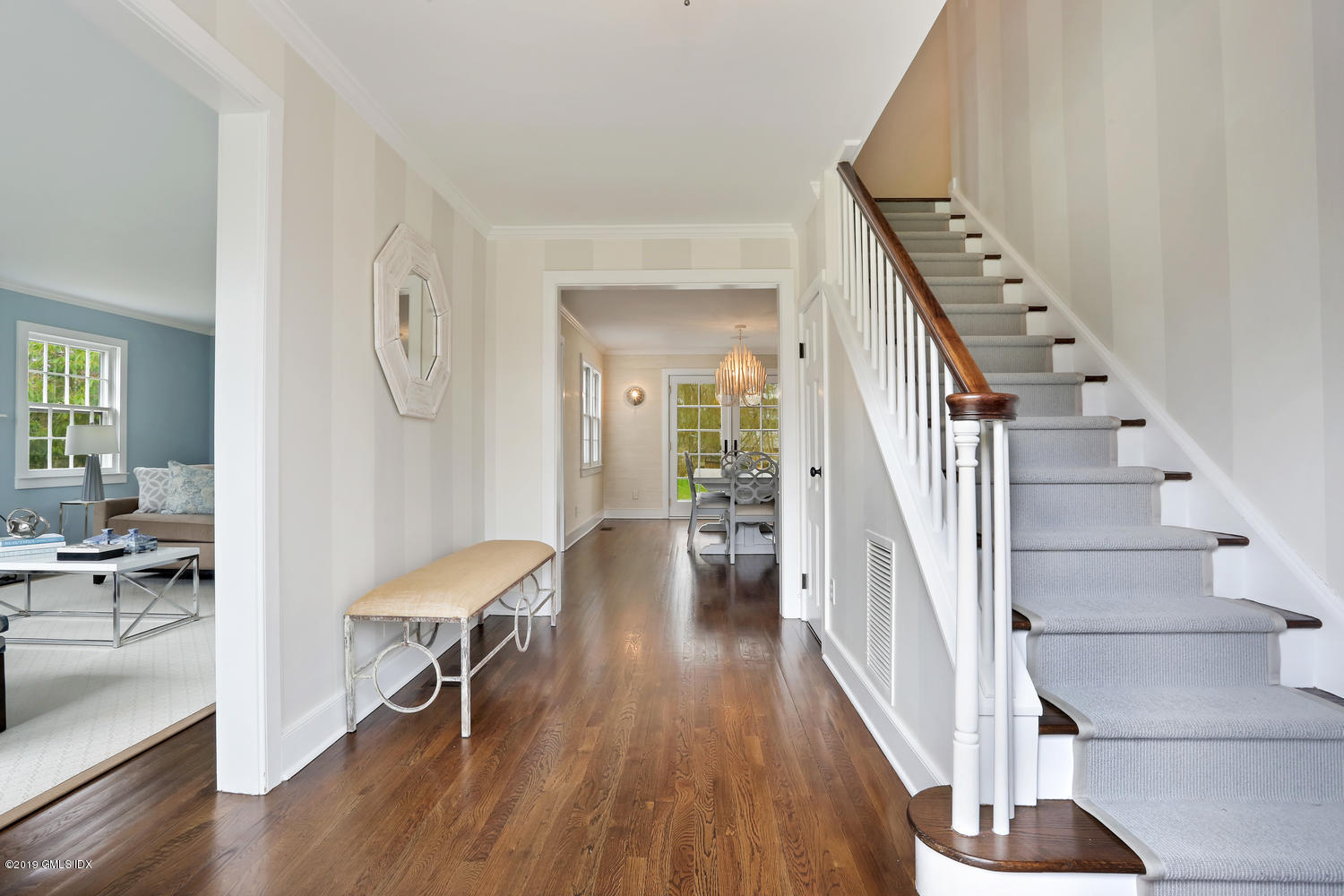 58 Indian Head Road Riverside, CT 06878 - Photo 3 of 33 a view of a hallway with wooden floor and staircase